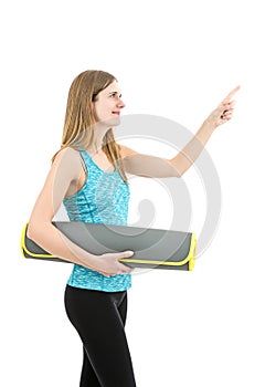 Young friendly fitness woman pointing to copy space