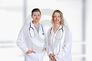 Young friendly medical team with book in lab coat