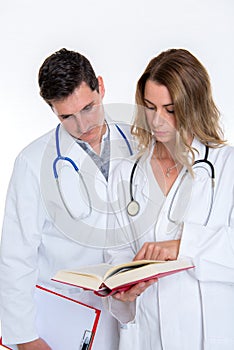 Young friendly medical team with book in lab coat
