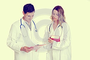 Young friendly medical team with book in lab coat