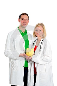 Young friendly medical team in lab coat with piggy bank