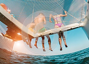 Young friends chilling in catamaran boat - Group of people making tour ocean trip - Travel, summer, friendship, tropical concept