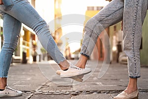 Young friends doing new social distancing greetings with foots for preventing corona virus outbreak