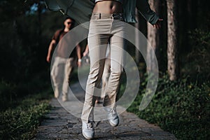 Young friends enjoying a carefree walk in the forest, feeling the fresh outdoor air