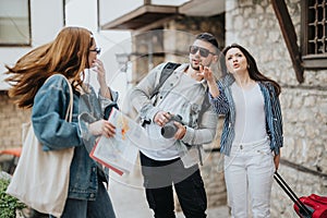 Young friends exploring a sunny city on vacation with a map and camera