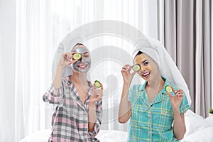 Young friends with facial masks having fun in room at party