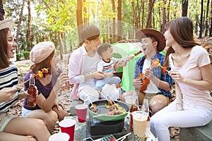young friends group enjoying picnic party and camping