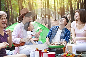 young friends group enjoying picnic party and camping