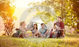 Young friends have good time on camping trip photo