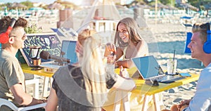 Young friends having fun making live streaming interview to an influencer at beach bar - Man doing video feed using phone camera