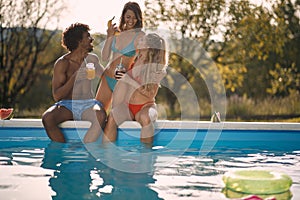 Young  friends having fun at summer in pool