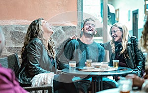 Young friends having genuine fun drinking on happy hour at street bar - Millenial people laughing and spending time together - photo