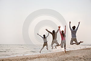 Young Friends Jumping at the Beach