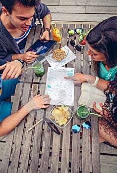 Young friends looking map over a table