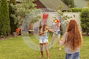 Young friends playing with water guns