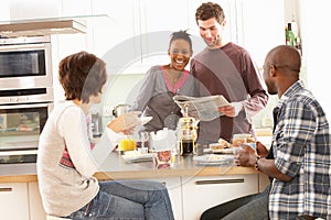 Young Friends Preparing Breakfast In Kitchen