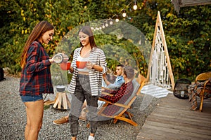 Young friends relax on picnic at camping