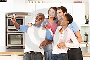 Young Friends Taking Photo In Kitchen