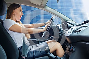 Young frightened driver woman squealing brakes