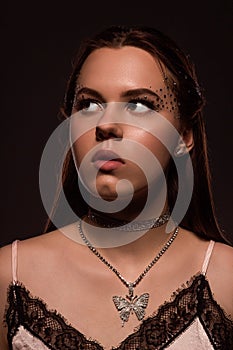 A young frightened woman looks away with apprehension.