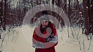Young frozen woman in in the header and red jacket. Adult female cringing from cold in winter season.