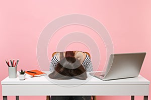 Young frustrated exhausted woman laid her head down on the table sit work at white desk with contemporary pc laptop