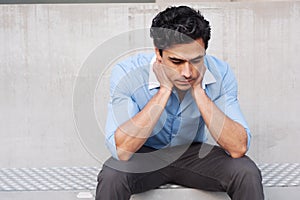 Young frustrated latino businessman