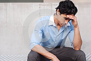 Young frustrated latino businessman photo