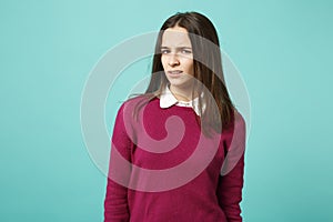 Young fun sad upset perplexed disturb brunette woman girl in red casual clothes posing isolated on blue wall background
