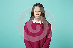 Young fun sad upset perplexed disturb brunette woman girl in red casual clothes posing isolated on blue wall background