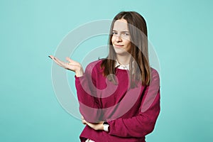 Young fun sad upset perplexed disturb brunette woman girl in red casual clothes posing isolated on blue wall background