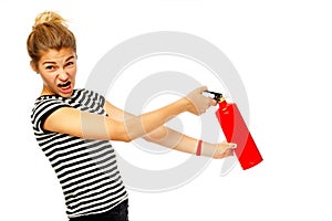 Young funny beautiful woman holding fire extinguisher over white