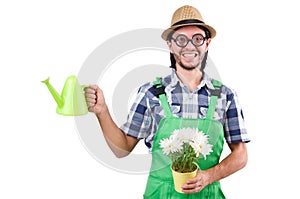 Young funny gardener with tulips and watering can