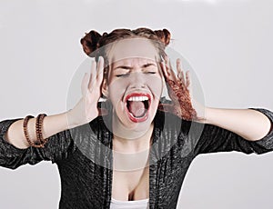 Young funny hipster woman showing tongue, shouting and surprise with funny emotion face.