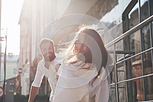 A young funny loving couple have fun on a sunny day.