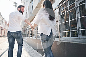 A young funny loving couple have fun on a sunny day.