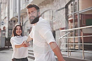 A young funny loving couple have fun on a sunny day.