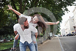 A young funny loving couple have fun on a sunny day.