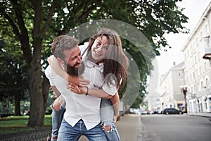 A young funny loving couple have fun on a sunny day.