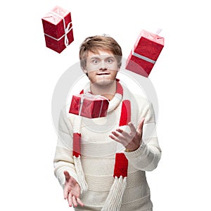 Young funny man juggle the christmas gifts