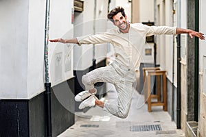 Young funny man jumping in the street.