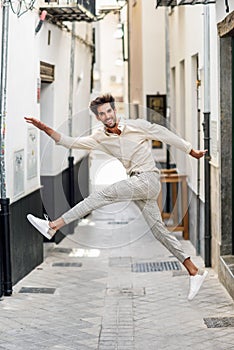Young funny man jumping in the street.