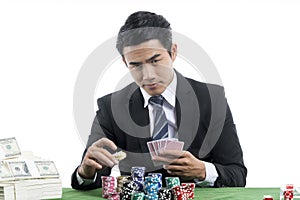 The young gambler is putting bets into the piles of chips