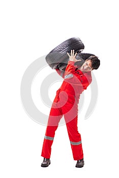 The young garage worker with tyre isolated on white