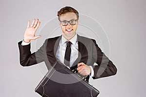 Young geeky businessman holding briefcase