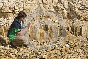Young geologist studying rock type
