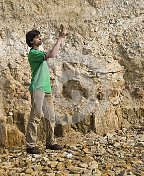 Young geologist studying rock type