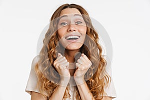 Young ginger woman laughing while holding clinched fists photo