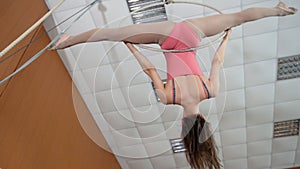 Young girl acrobat shows flexibility on gymnastic hoop