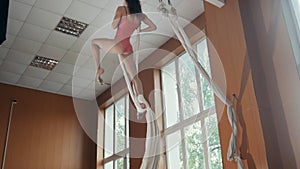 Young girl acrobat shows flexibility on gymnastic hoop